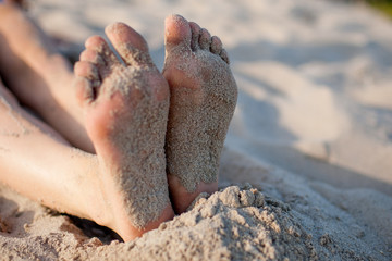 girl's feet on sand