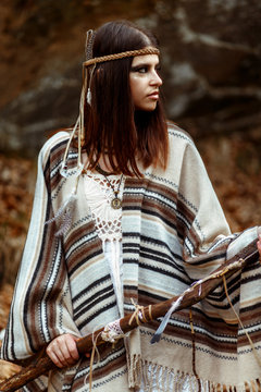 beautiful boho tribal woman holding pikestaff