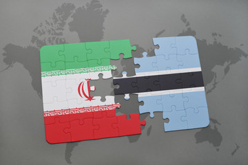 puzzle with the national flag of iran and botswana on a world map background.