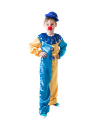 Pensive boy dressed as a clown with a red nose holding hands on flanks and looking to the side on a white background