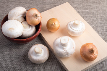 Raw champignon mushrooms and onions