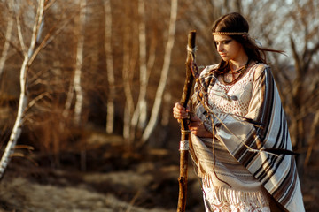 boho  woman shaman on hill  in sunset evening 