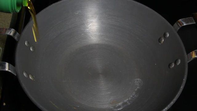 Adding sliced onions to olive oil and stiring