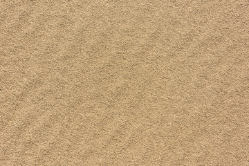 Fototapeta na wymiar Textured sand of yellow color as background.