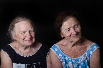 Portrait of two elderly sisters. Smile