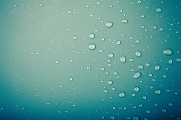 Drops of water on a color background. Green. Toned