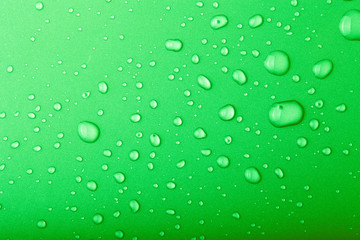 Drops of water on a color background. Green. Toned