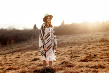 beautiful boho woman hipster enjoying sunset and posing at sun l