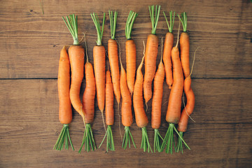 Fresh raw carrots on wooden table