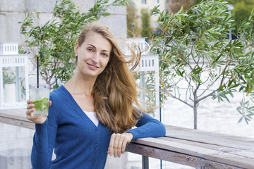 Beautiful Woman with mojito cocktail. Summer.