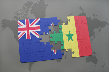 puzzle with the national flag of new zealand and senegal on a world map background.