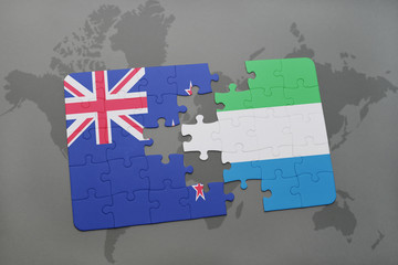 puzzle with the national flag of new zealand and sierra leone on a world map background.