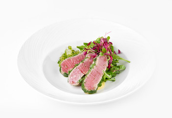 Tuna in herbs with ginger melon on a plate on a white background