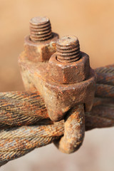 Rusty  wire grip lock, cable clamp turnbuckle with selective focus.