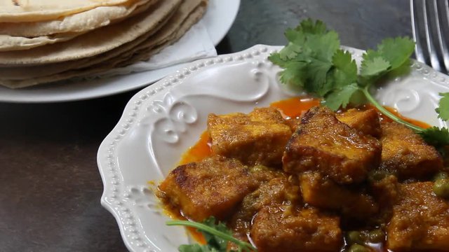Plated Paneer butter masala with chapati or roti on the side