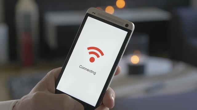 man holding a smartphone that connects to wifi