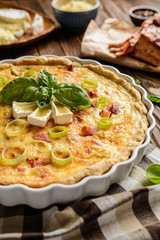 Traditional French Quiche Lorraine with Cheddar, Camembert, bacon and eggs