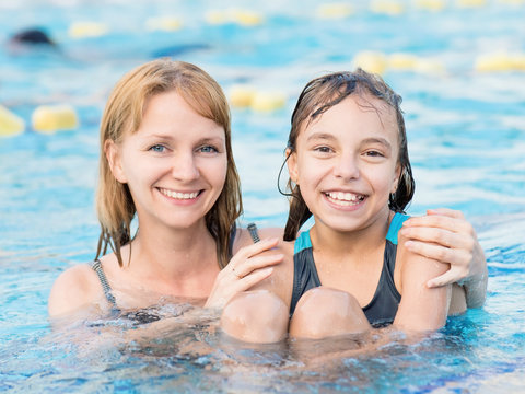 Mother and daughter in pool