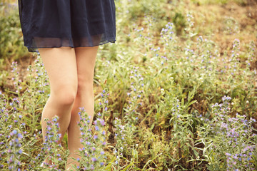 Woman legs on grass background