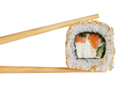 Tasty sushi roll with wooden chopsticks on white background