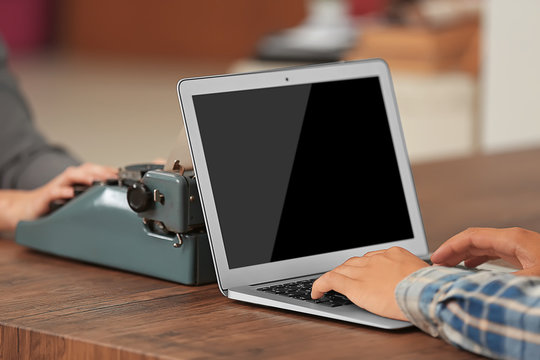 Old typewriter and laptop, concept of technology progress