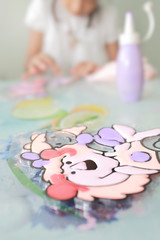 Blurry of young girl doing artwork with color . defocused and soft color toned.