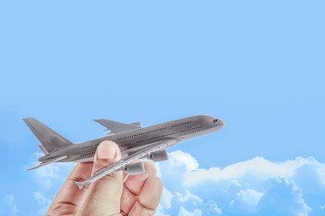 plane in hand against blue sky