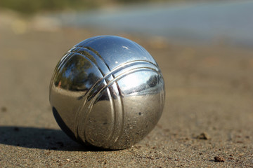 Fototapeta na wymiar Petanque ball on sand close up.