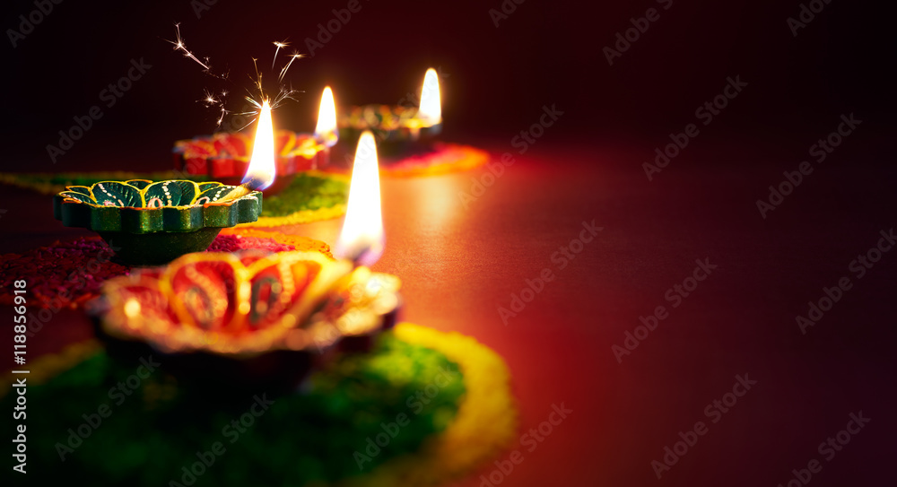 Wall mural Colorful clay diya lamps lit during diwali celebration