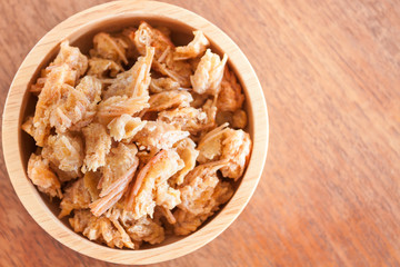 Fried shrimp chins snack in wooden bowl