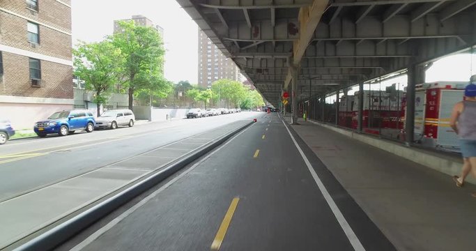 A bicycle rider's perspective on the East River Bikeway trail underneath FDR Drive in Manhattan.	 	