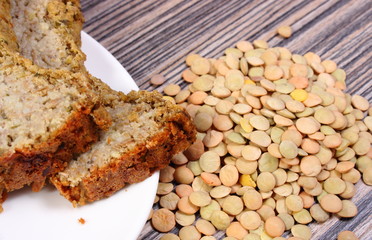 Heap of lentil and homemade pie on wooden background