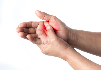 Senior woman touching her injured hand on white background,suffering pain concept