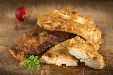 Chicken schnitzel on wood
