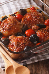 Roasted pieces of chicken with mustard, tomatoes and mushrooms. Vertical
