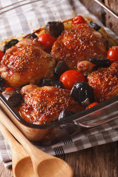 Roasted pieces of chicken with mustard, tomatoes and mushrooms. Vertical
