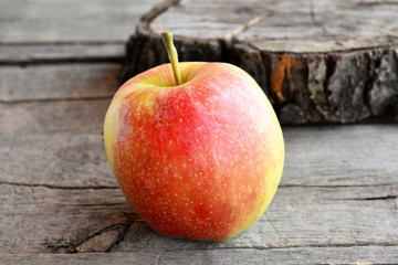 Sweet juicy apple isolated on old wooden background. A large red apple. Closeup