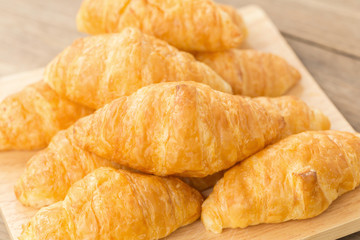 fresh croissants on wooden table