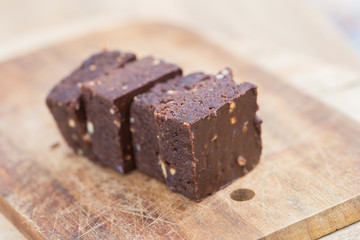 Homemade chocolate brownies over wooden background