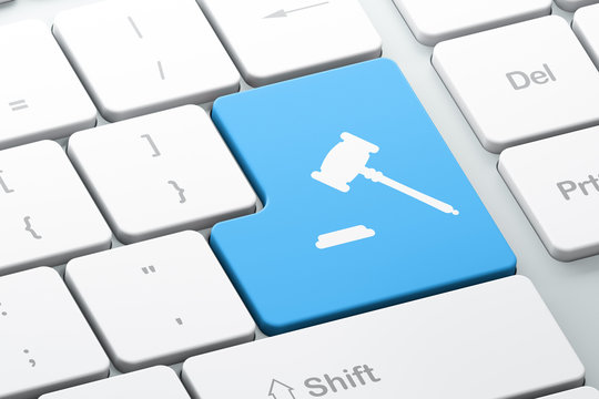 Law concept: Gavel on computer keyboard background
