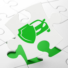 Insurance concept: Car And Shield on puzzle background