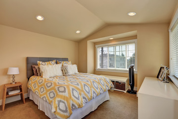Vaulted ceiling bedroom interior in beige colors