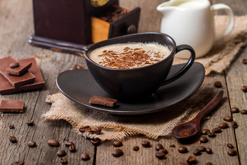 Cup of coffee with  beans and chocolate