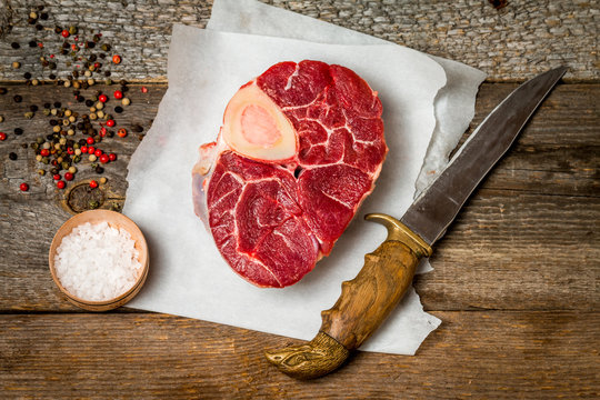 Raw fresh cross cut veal shank and meat cleaver