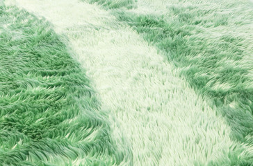 Closeup surface abstract fabric pattern at the green fabric carpet at the floor of house texture background