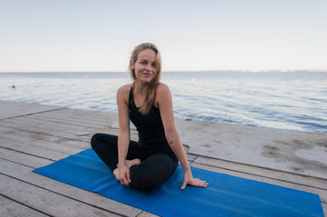 Woman Yoga - relax in nature near the lake