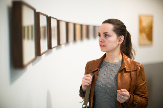 Young woman at gallery exhibition