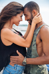 Romantic beautiful couple in love embracing at the pier