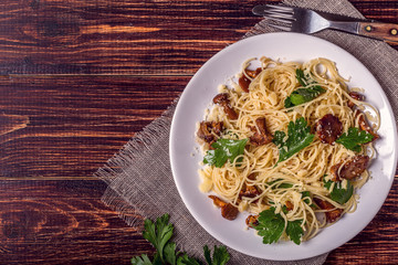 Pasta spaghetti with chanterelles mushrooms on wooden background