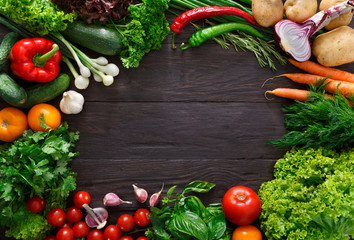 Frame of fresh vegetables on wooden background with copy space